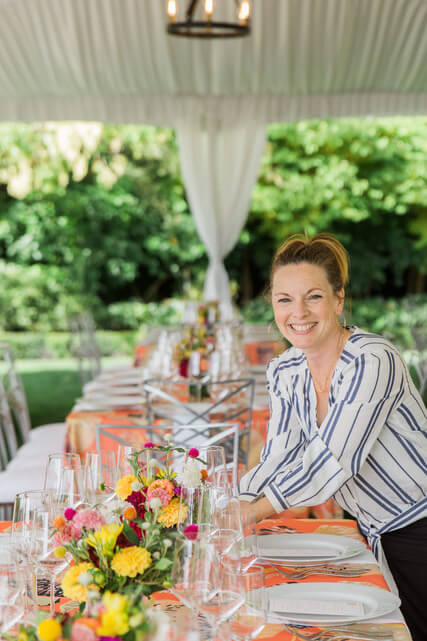 jean louise placing centerpieces on a long king's table